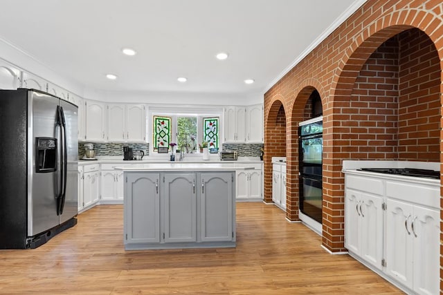 220 Oconnor Dr, Milledgeville, GA 31061 - kitchen featuring stainless steel fridge with ice dispenser, ornamental molding, white cabinetry, light countertops, and decorative backsplash