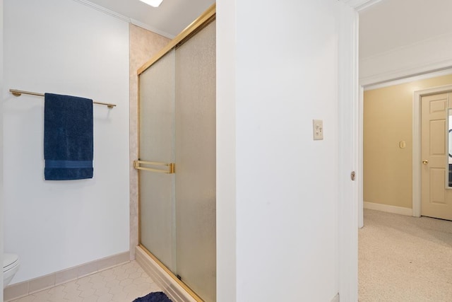 220 Oconnor Dr, Milledgeville, GA 31061 - bathroom featuring a stall shower, baseboards, toilet, and ornamental molding