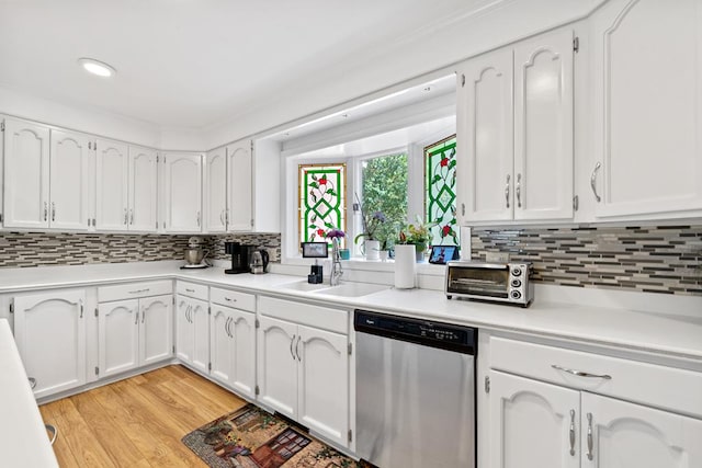 220 Oconnor Dr, Milledgeville, GA 31061 - kitchen featuring stainless steel dishwasher, white cabinets, decorative backsplash, light countertops, and recessed lighting