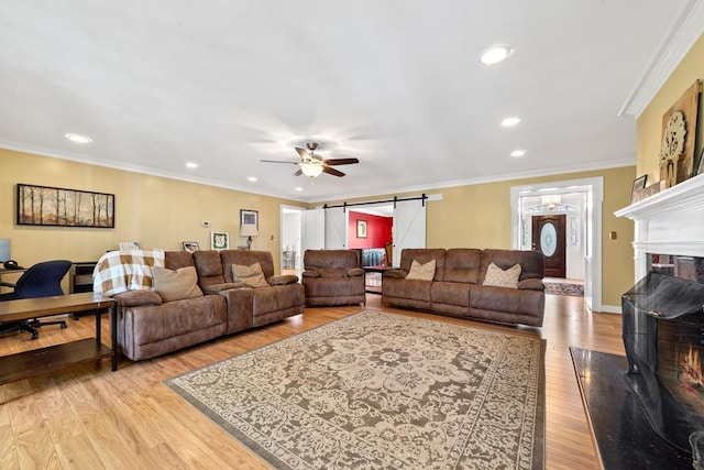 220 Oconnor Dr, Milledgeville, GA 31061 - living area featuring a barn door, ceiling fan, light wood finished floors, a premium fireplace, and recessed lighting
