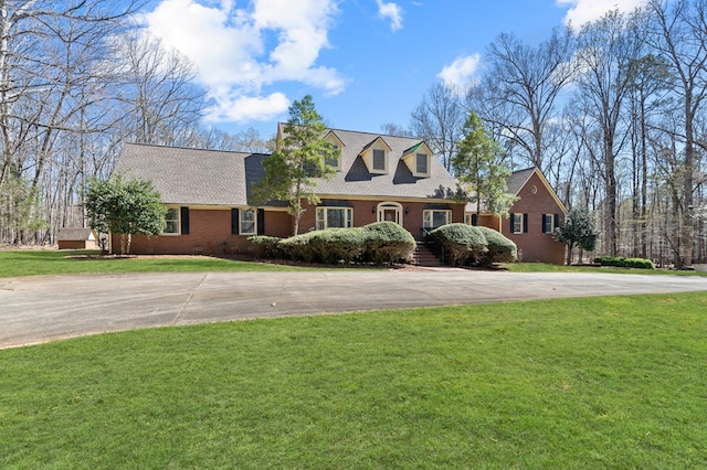 220 Oconnor Dr, Milledgeville, GA 31061 - new england style home with driveway, a front lawn, and brick siding