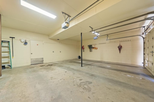 220 Oconnor Dr, Milledgeville, GA 31061 - garage with a garage door opener and concrete block wall