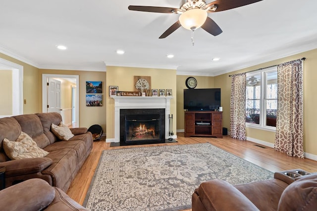 220 Oconnor Dr, Milledgeville, GA 31061 - living area with a fireplace with flush hearth, wood finished floors, ornamental molding, baseboards, and ceiling fan