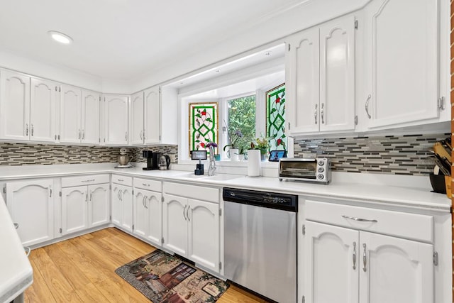 220 Oconnor Dr, Milledgeville, GA 31061 - kitchen with stainless steel dishwasher, a sink, white cabinets, tasteful backsplash, and recessed lighting