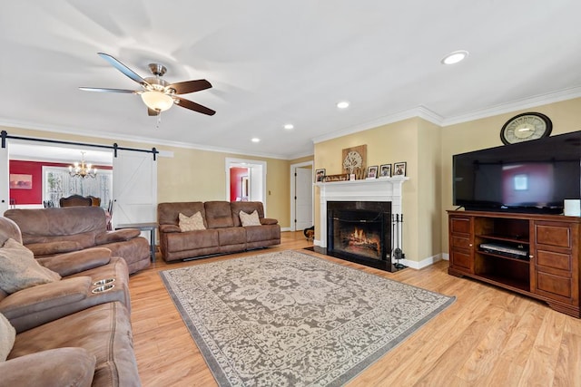220 Oconnor Dr, Milledgeville, GA 31061 - living area featuring a barn door, a ceiling fan, a high end fireplace, light wood-type flooring, and crown molding