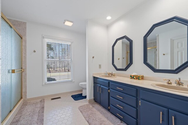 220 Oconnor Dr, Milledgeville, GA 31061 - full bath featuring double vanity, toilet, a shower stall, baseboards, and crown molding