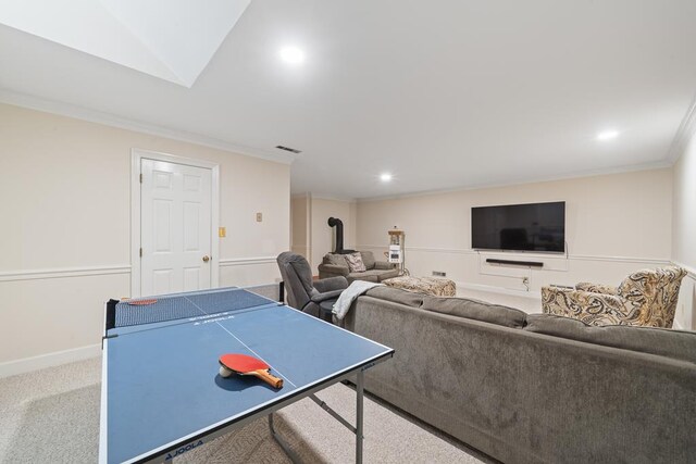 220 Oconnor Dr, Milledgeville, GA 31061 - recreation room featuring crown molding, recessed lighting, a wood stove, carpet flooring, and baseboards