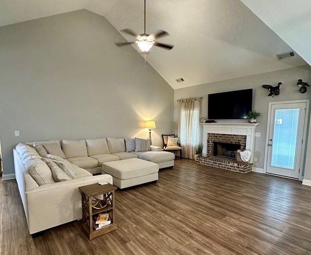 living area with visible vents, a fireplace, ceiling fan, and dark wood-style flooring