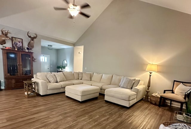 living area with a ceiling fan, wood finished floors, and high vaulted ceiling