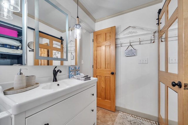 bathroom featuring baseboards, ornamental molding, and vanity