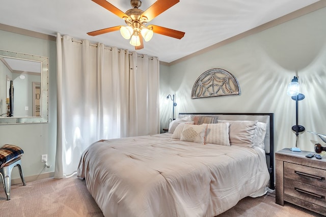 bedroom featuring light carpet, a ceiling fan, baseboards, and crown molding