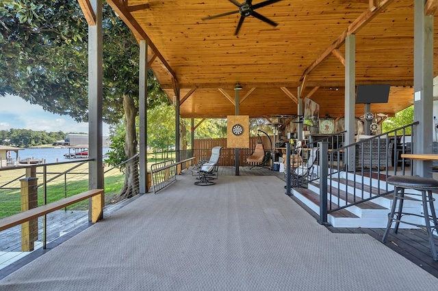 exterior space featuring a ceiling fan and a water view