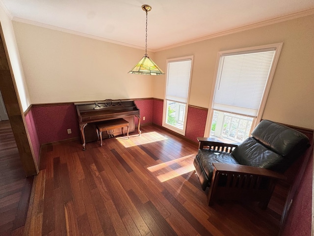 living area featuring a wainscoted wall, crown molding, and hardwood / wood-style floors