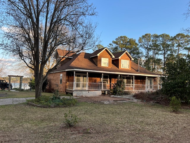 view of front of home featuring covered porch and a front lawn