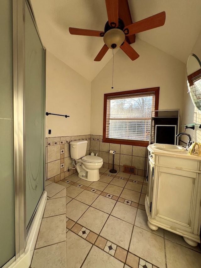 bathroom with vanity, lofted ceiling, an enclosed shower, and toilet