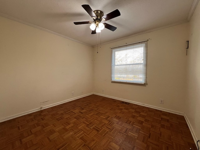 empty room featuring ceiling fan, dark parquet flooring, ornamental molding, and a textured ceiling