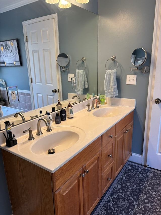 bathroom with ornamental molding, tile patterned floors, a sink, and double vanity