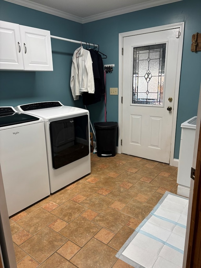 washroom featuring stone finish floor, cabinet space, crown molding, and washing machine and clothes dryer