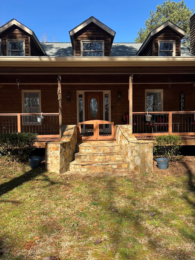 view of front of house featuring a front yard and covered porch