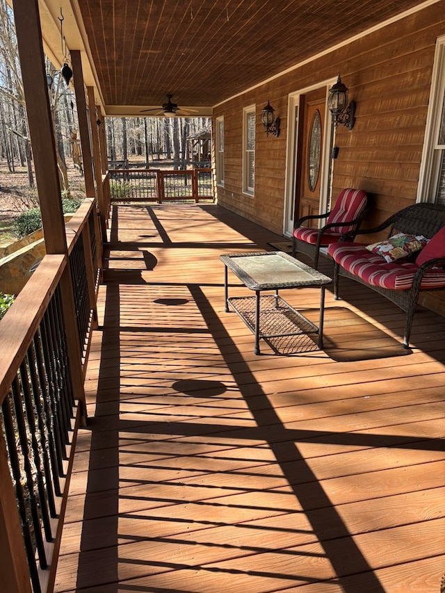 wooden deck featuring a ceiling fan and a porch