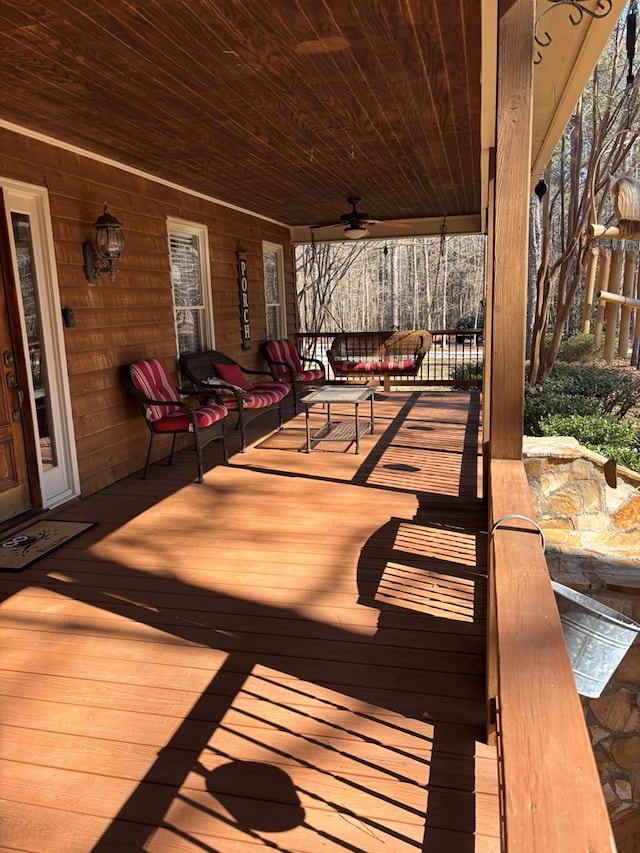 deck with a porch and ceiling fan