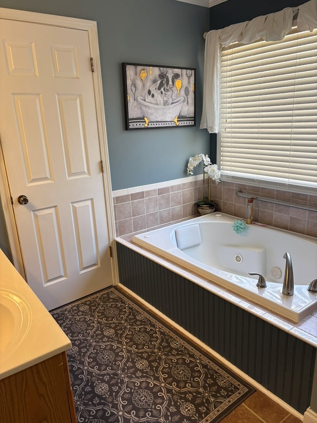 full bath featuring tile patterned flooring, a tub with jets, and vanity