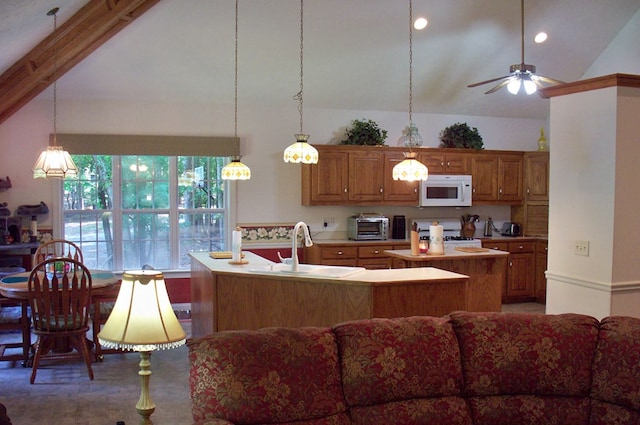 307 E River Bend Dr, Eatonton, GA 31024 - kitchen with white microwave, a sink, a kitchen island, light countertops, and stove