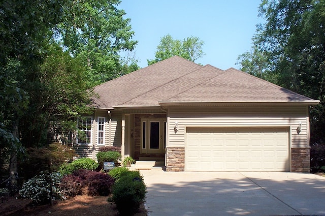 307 E River Bend Dr, Eatonton, GA 31024 - view of front of house featuring driveway, stone siding, a garage, and roof with shingles
