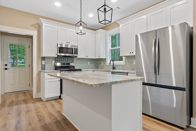 172 Southshore Rd, Eatonton, GA 31024 - kitchen featuring appliances with stainless steel finishes, white cabinets, recessed lighting, and decorative backsplash