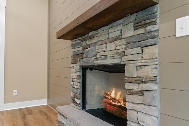 172 Southshore Rd, Eatonton, GA 31024 - detailed view of a fireplace, wood finished floors, and wood walls
