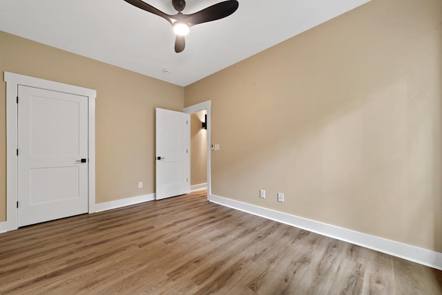 172 Southshore Rd, Eatonton, GA 31024 - unfurnished bedroom with wood finished floors and ceiling fan