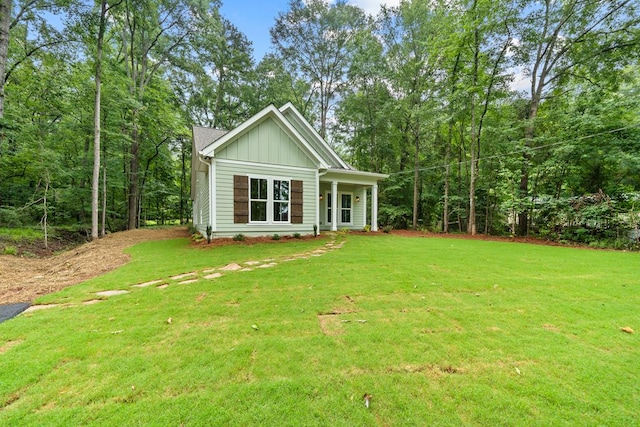 172 Southshore Rd, Eatonton, GA 31024 - rear view of property with board and batten siding and a yard