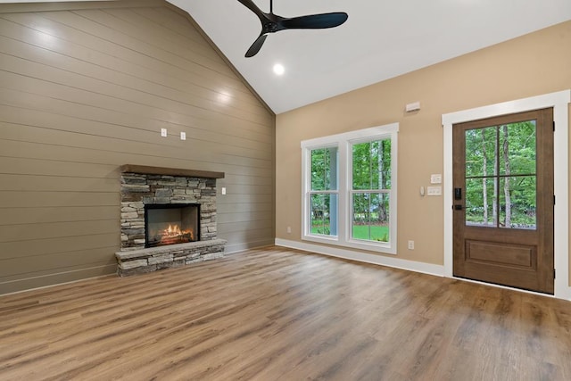 172 Southshore Rd, Eatonton, GA 31024 - unfurnished living room with ceiling fan, wood finished floors, high vaulted ceiling, a fireplace, and wood walls