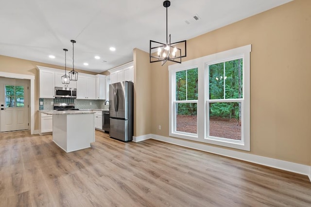 172 Southshore Rd, Eatonton, GA 31024 - kitchen featuring stainless steel appliances, recessed lighting, decorative backsplash, white cabinetry, and light wood finished floors