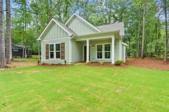 172 Southshore Rd, Eatonton, GA 31024 - view of front facade with board and batten siding, a front lawn, and roof with shingles