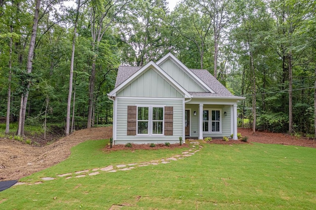 172 Southshore Rd, Eatonton, GA 31024 - view of front of house featuring board and batten siding, roof with shingles, and a front lawn