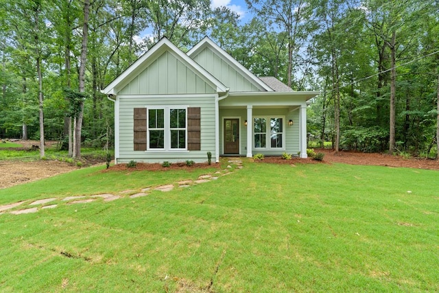 172 Southshore Rd, Eatonton, GA 31024 - view of front of home featuring board and batten siding, a front yard, and a porch