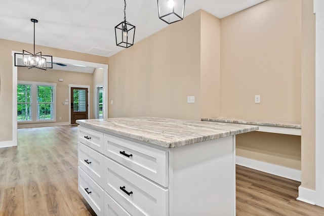 172 Southshore Rd, Eatonton, GA 31024 - kitchen with light wood-style floors, white cabinetry, pendant lighting, light stone countertops, and a center island
