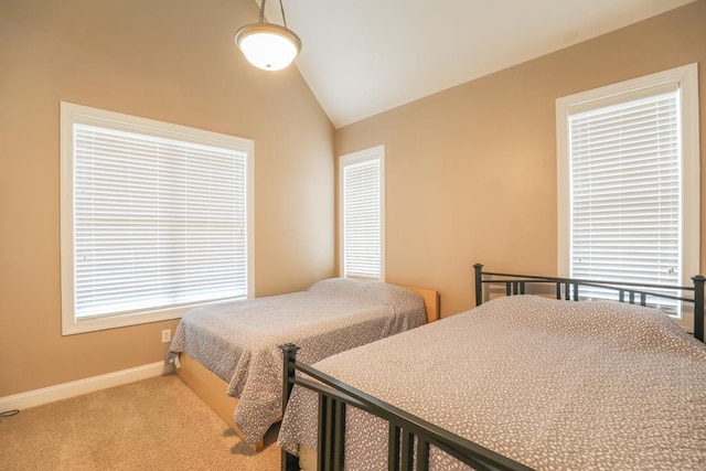 carpeted bedroom with lofted ceiling