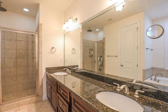 bathroom with shower with separate bathtub, vanity, and tile patterned floors