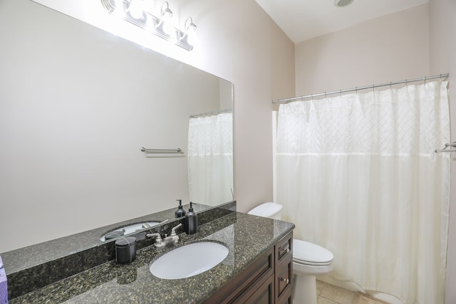 bathroom featuring tile patterned floors, vanity, and toilet