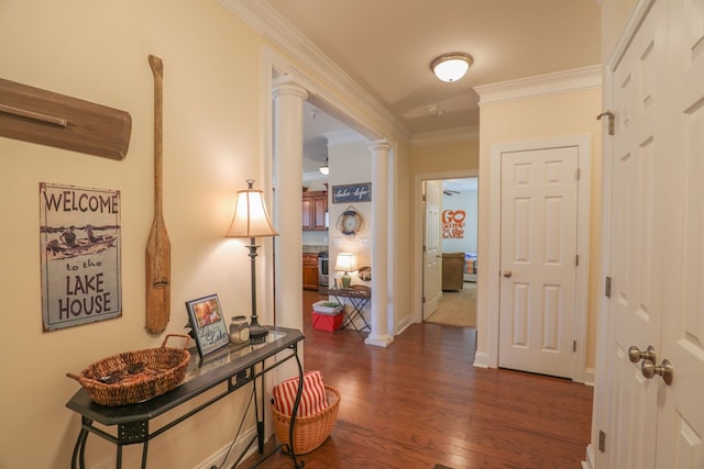 hall featuring ornate columns, dark hardwood / wood-style floors, and ornamental molding