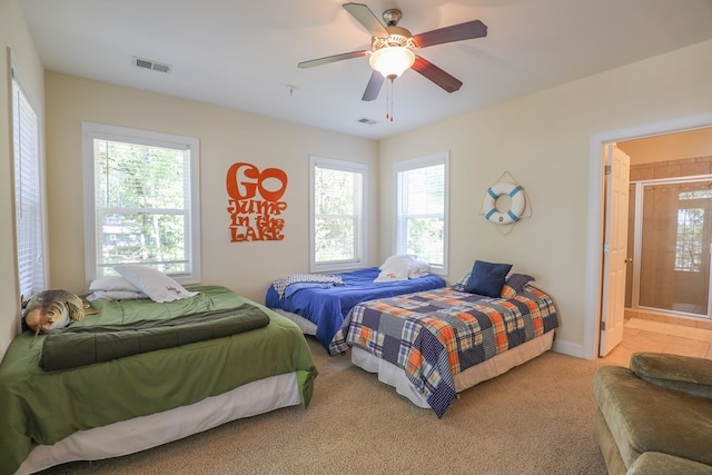 bedroom with ceiling fan, carpet floors, connected bathroom, and multiple windows