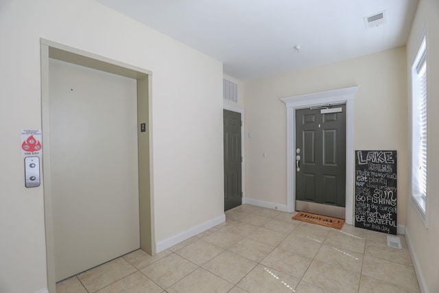 tiled entrance foyer featuring elevator