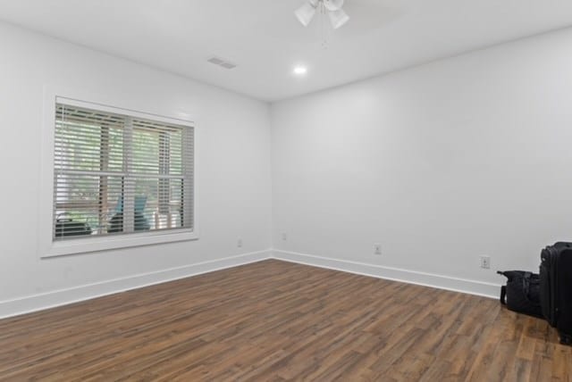 spare room featuring ceiling fan and dark hardwood / wood-style flooring