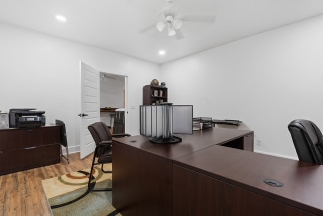 office with ceiling fan and light wood-type flooring