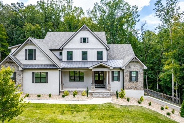 view of front of house featuring a front yard and a porch