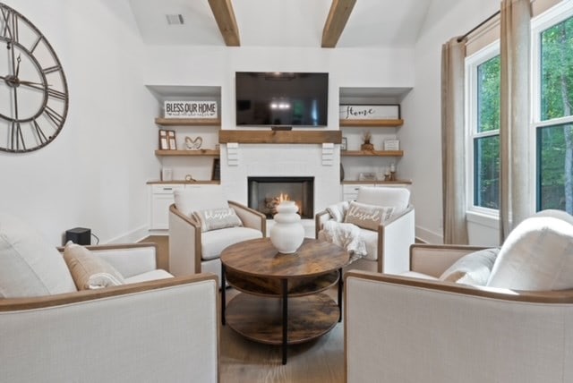 living room featuring wood-type flooring and beam ceiling