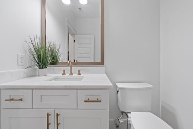 bathroom featuring vanity and toilet