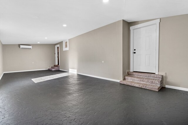 174 Main St, Toomsboro, GA 31090 - below grade area featuring a wall mounted air conditioner, recessed lighting, and baseboards